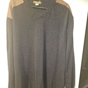 Blue sweater, with brown leather in the elbows.